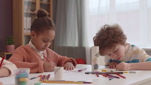 Multiethnic Elementary School Kids Drawing in Classroom