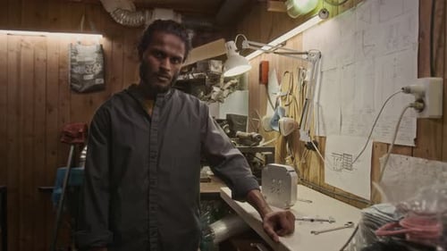 Portrait of Indian Male Technician with Lathe and Drafts in Workshop
