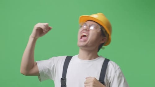 Asian Man Worker Wearing Goggles And Safety Helmet Singing And Dancing In The Green Screen