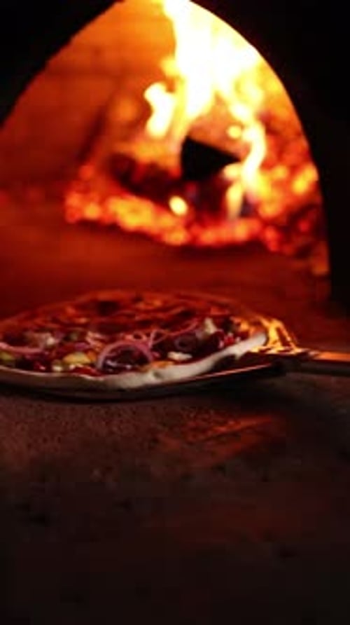 Pizza Baking Inside a Fire Burning Oven