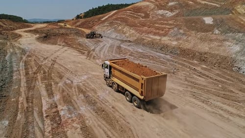 Truck Transports Soil at Expansive Construction Site