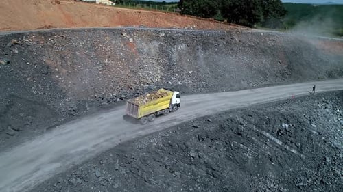 Dump Truck Transporting Soil on Road Construction Site