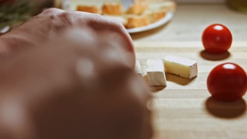 Cutting Brie Soft Cheese on a Cutting Board