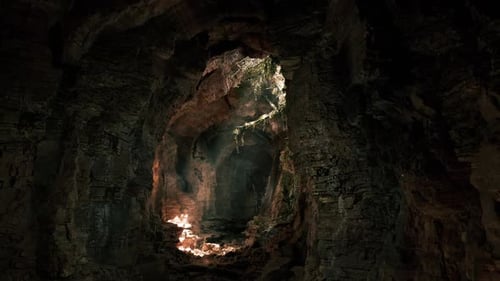 Exploring a Hidden Cave with Glowing Rock Formations and Vegetation