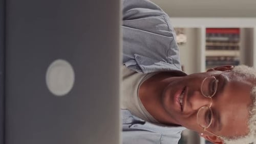 Young Adult Working on Laptop at Home