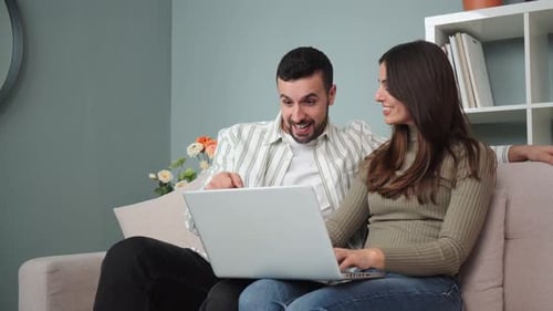 Happy Couple Shopping Online Together at Home