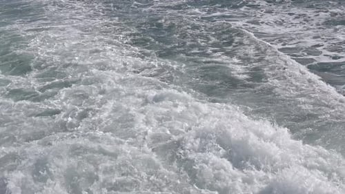 Cinematic Close-Up of Turbulent Boat Wake and White Foam on Ocean