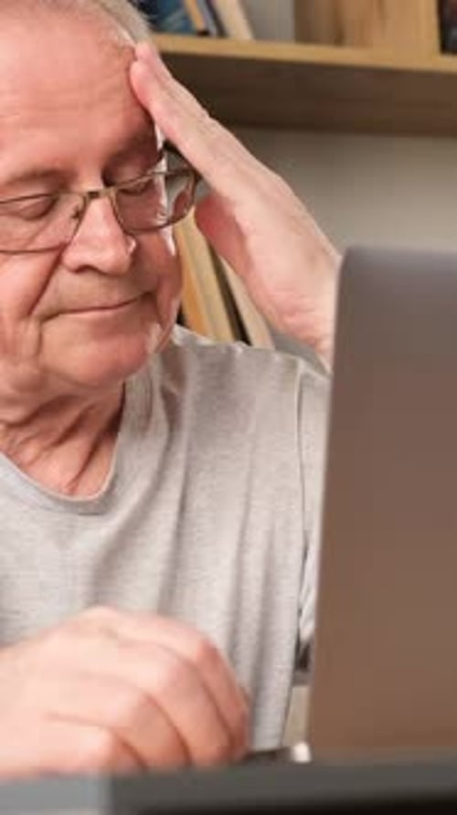 Senior Man Using Laptop at Home