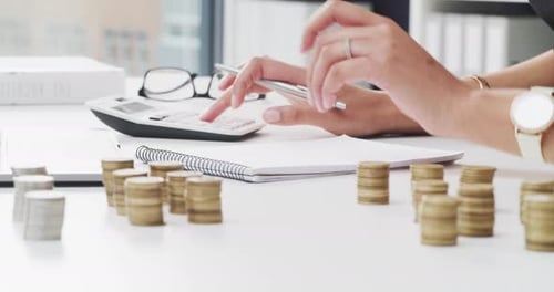 4k video footage of an unrecognizable businesswoman stacking coins while working in her office