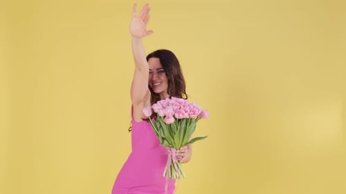 Woman With Flowers Waving on Yellow Background