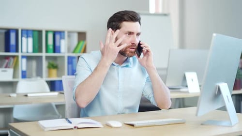 Angry mad businessman talking on cellphone in office. enraged furious employee, entrepreneur, office