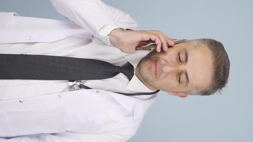 Doctor Talking on Mobile Phone Wearing White Coat