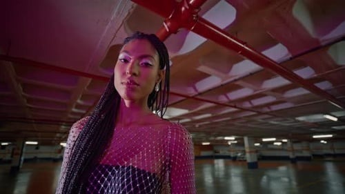 Glamorous Woman with Braids Posing in Garage