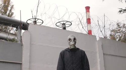 Person in Gas Mask Standing Near Factory Chemical Weapon Protection