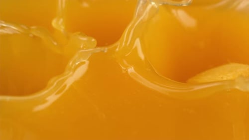 Chunks of Juicy Mango Splashing into Mango Juice