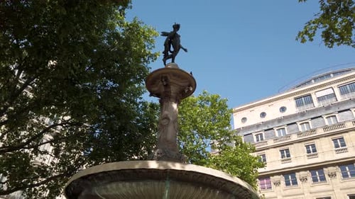 Low angle of small fountain in Paris with no water