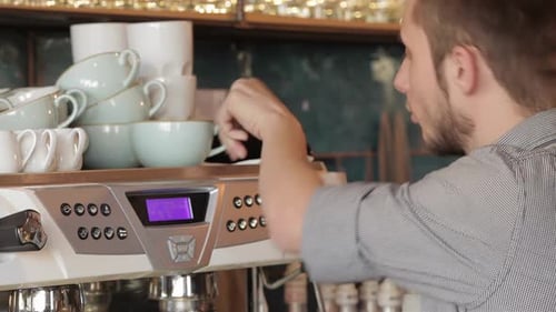 Barista Making Espresso in a Bright Coffee Shop