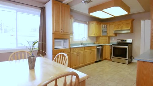 A outdated kitchen and living room space inside a residential family home