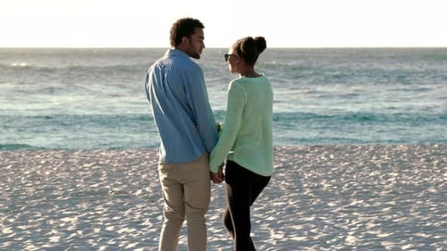 4K video footage of a young couple enjoying the day together at the beach