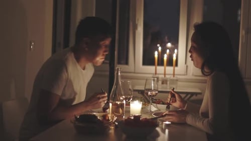 Couple Having Romantic Candlelit Dinner at Home