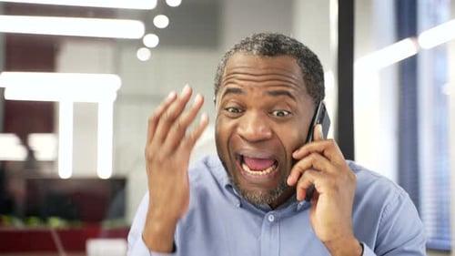 Furious Man Arguing on Phone in Office