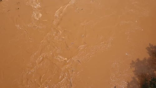 high angle above flooded muddy river current, after heavy rains in forest area