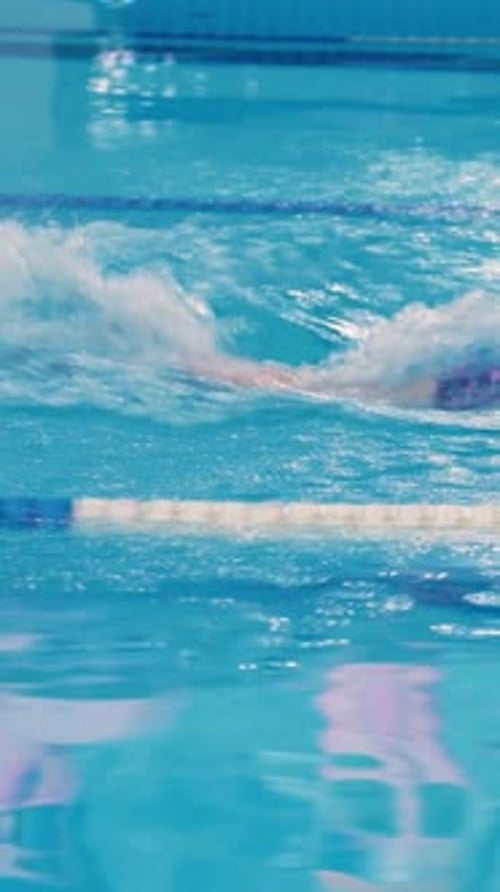A Male Swimmer Swims in a Swimming Pool Enjoying Process and Training His Body A Professional Man