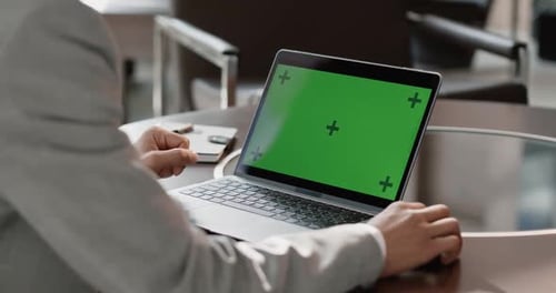 Office Firstperson View Businessman Working on a Laptop with a Green Screen Coworking Chroma Key