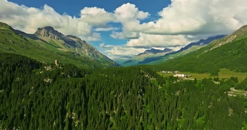Drone Flies Over Green Picturesque Valley with Mountains in the Background High Mountains Famous