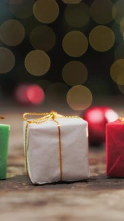 Santa Claus Hands Mini Christmas Gift Packages On The Table