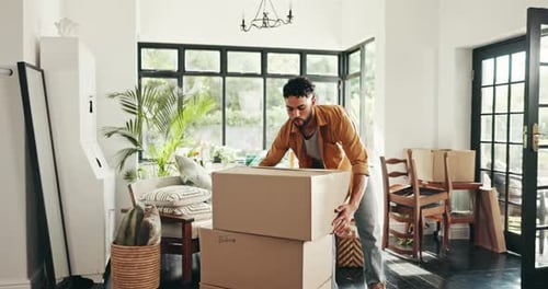Man, relocation and moving boxes in home, happy and property investment or real estate mortgage