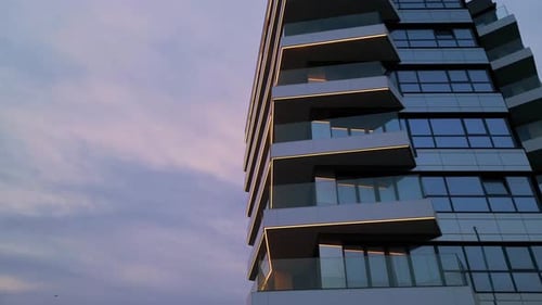 Modern Highrise Residential Building with Glowing LED Lines and Glass Balconies at Twilight Elegant