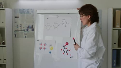 Scientist Explains Molecular Structures on Whiteboard