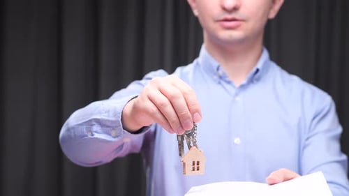 Real Estate Agent Holding House Keys and Contract