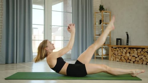 Woman Exercising with Weight at Home on Yoga Mat