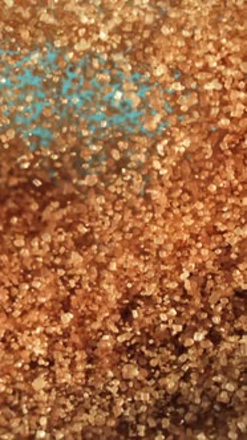 Cane Sugar Soars Against a Blue Background Filmed on a Highspeed Camera at 1000 Fps