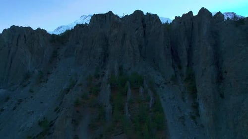 Aerial Ascending View Himalaya Mountains Panorama with Snowy Peaks and Sun Behind Mountain Majestic