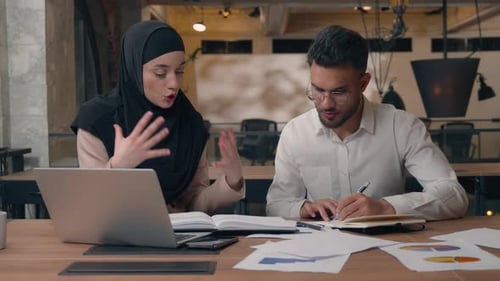 Business Colleagues Discussing Project at Desk in Office