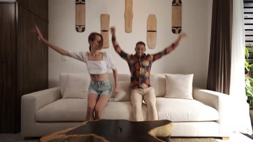 Couple Dancing Together at Home, Jumping on Couch