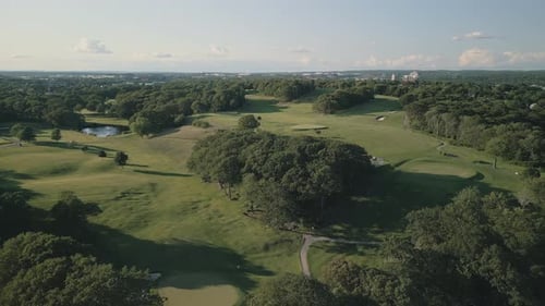 Aerial View of Green Grass and Trees on a Golf Field at a Beautiful Sunset