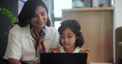 Woman and Child Using Laptop at Home