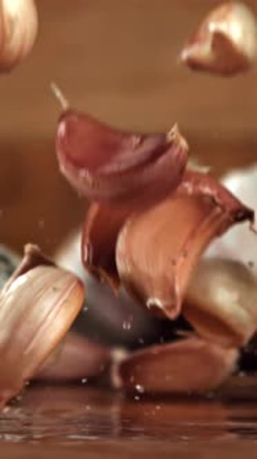 Garlic Falls on a Wooden Table Filmed on a Highspeed Camera at 1000 Fps