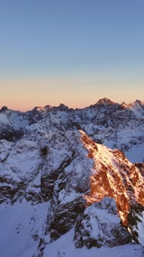 Breathtaking views across the snow-covered Alps during sunset