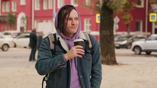 Hipster Man with Dreadlocks Drinking Hot Coffee on Street