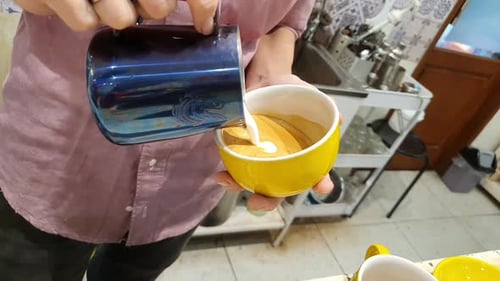 Barista making of cafe latte art, heart shape