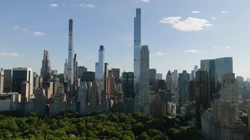 Drone shot backwards over the Central park with Manhattan skyscraper background