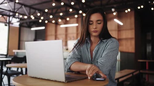 Bored Young Woman Sitting Alone In Cafe Looking At Laptop Display Waiting For Answer And Messages