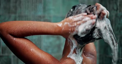 Woman Showering and Applying Lotion in Bathroom