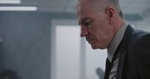 Close Up of Male Detective in Suit Examining Evidence at Crime Scene