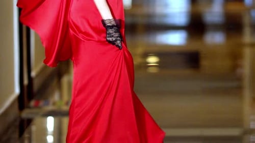 Elegant Woman in Red Dress Posing in Hallway
